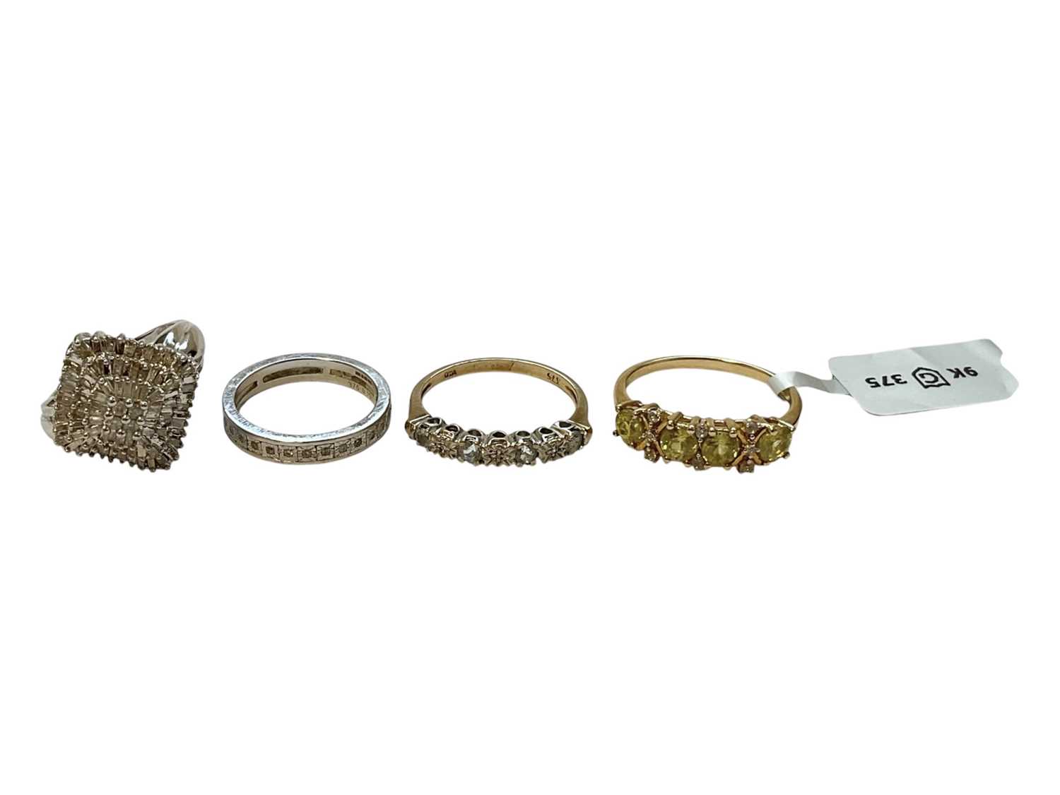 Lot 135 - Diamond cluster ring with a cluster of diamonds totalling 0.50cts in 9ct white gold setting, together with three other 9ct gold and gem-set dress rings (4)