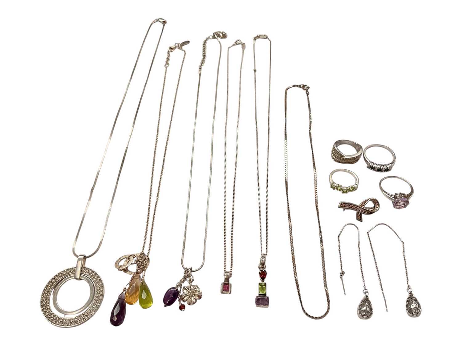 Lot 140 - Small group of silver and white metal jewellery to include gem set dress rings, pendants on chains, a brooch and a pair of drop earrings