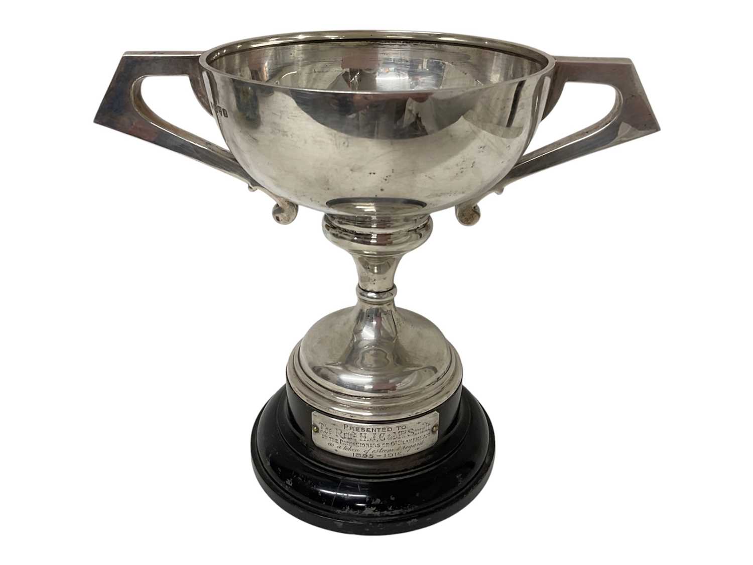 Lot 154 - Large silver two handled trophy (Chester 1911) on an ebonised wood base with an applied white metal presentation plaque