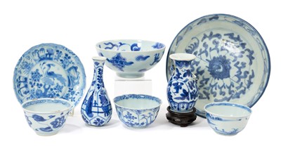 Lot 45 - Group of mostly 18th century Chinese blue and white porcelain, including a dragon bowl with six character Yongzheng mark, a shipwreck tea bowl and saucer, etc, and a wooden stand (9)