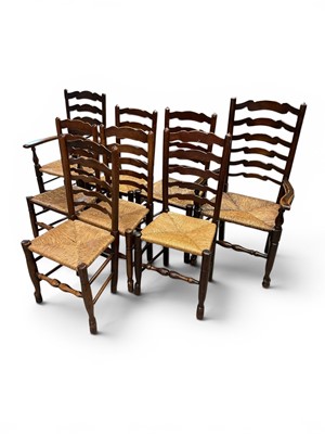 Lot 1311 - Matched set of nine 19th century oak ladder back chairs with rush seats