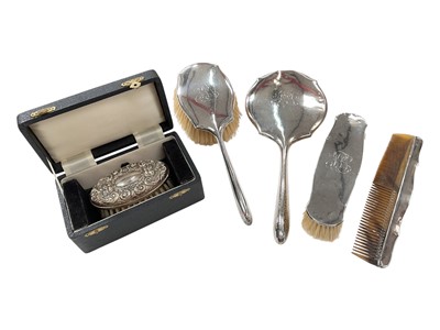 Lot 271 - Four piece silver dressing table set with engraved monogram and a silver hand brush in fitted box