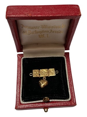 Lot 83 - Antique French gold clasp with engraved foliate scroll decoration and a heart pendant suspended below