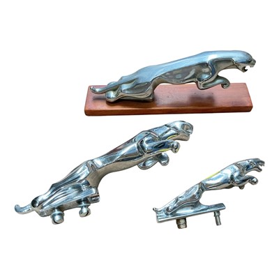 Lot 4 - Group of three Jaguar cars leaper mascots, one mounted on a wooden base, (3).
