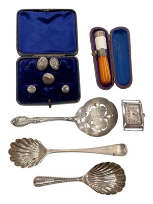 Lot 1056 - Two silver caddy spoons, Gorham Sterling silver sifter spoon, vintage silver cased watch, silver studs and a silver mounted amber cheroot holder