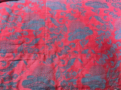 Lot 2583 - Hand stitched bed quilt, damask / brocade red ground with woven floral design. Quilting is in diamond pattern. 200 cm x 220 cm approximately.