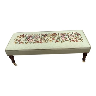Lot 5307 - Victorian style long footstool with floral upholstery on turned legs and brass capped ceramic castors, 101cm x 43cm x 31cm high