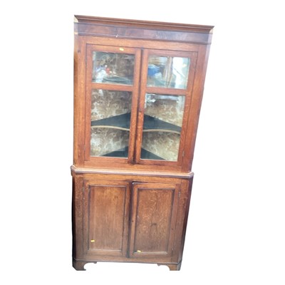 Lot 5342 - George III oak glazed two height corner cupboard