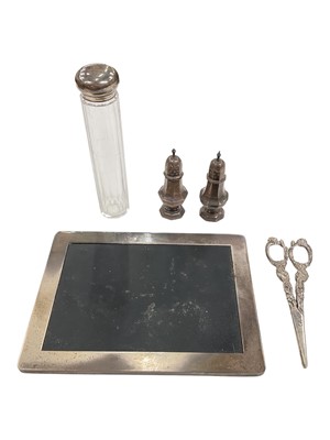 Lot 139 - Silver mounted mouse mat, pair of silver pepperettes, pair of Continental silver (800) grape scissors and a silver topped glass bottle (5)