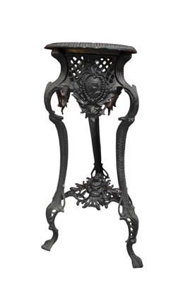 Lot 1487 - Cast iron jardinière stand, in the rococo style with mask and pierced C-scrolling ornament on three supports, 75cm high