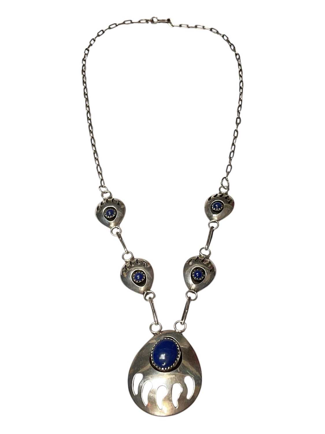 Lot 61 - Navajo sterling silver and blue stone pendant necklace with stylised bear claw decoration