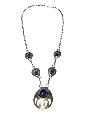 Lot 61 - Navajo sterling silver and blue stone pendant necklace with stylised bear claw decoration