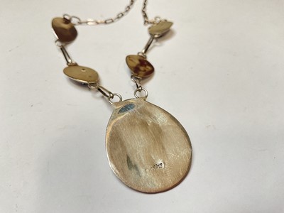 Lot 61 - Navajo sterling silver and blue stone pendant necklace with stylised bear claw decoration
