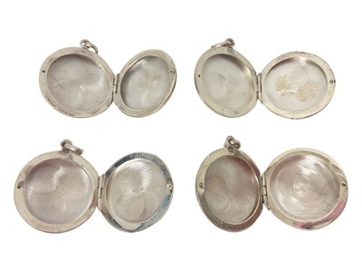 Lot 63 - Four contemporary silver and enamel circular lockets depicting a jockey, cavalry soldier, golfer and ducks