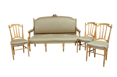 Lot 1325 - Early 20th century Continental carved gilt frame settee, arched back with ribbon cresting, with striped upholstery, together with a set of three conforming salon chairs