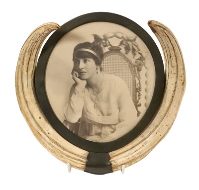 Lot 934 - Pair of Edwardian warthog tusks, mounted as a photograph frame with brass mounts, 23cm x 24cm