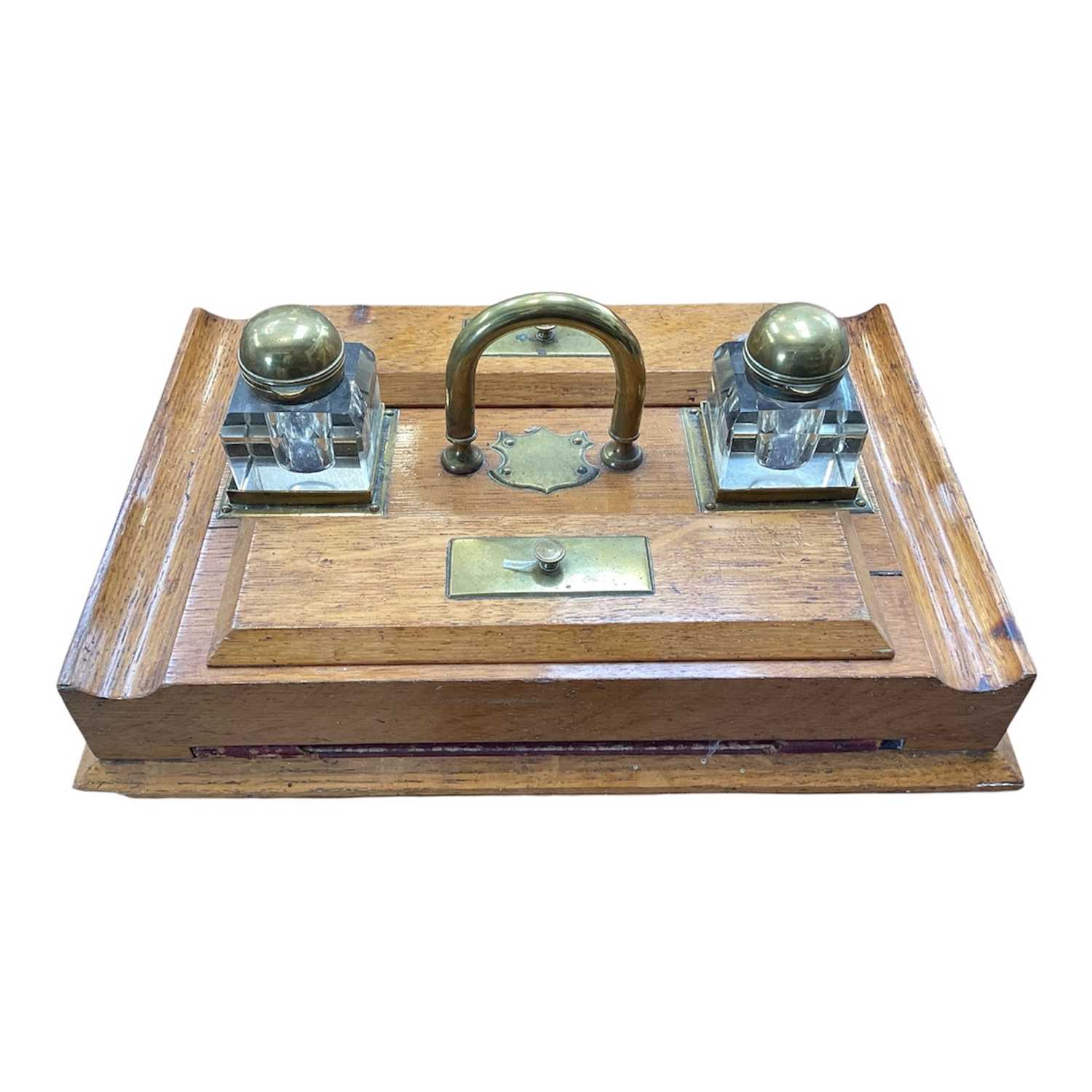 Lot 5100 - Edwardian oak inkstand with two cut glass bottles, 38cm wide