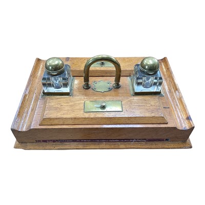 Lot 5100 - Edwardian oak inkstand with two cut glass bottles, 38cm wide