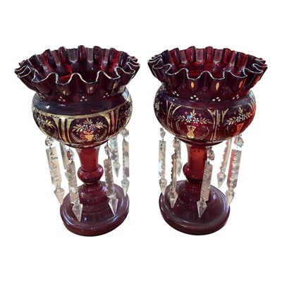 Lot 5102 - Pair of Bohemian ruby red lustres with prismatic drops, enamelled and gilt floral decoration, 27cm high