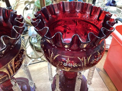 Lot 5102 - Pair of Bohemian ruby red lustres with prismatic drops, enamelled and gilt floral decoration, 27cm high