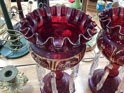 Lot 5102 - Pair of Bohemian ruby red lustres with prismatic drops, enamelled and gilt floral decoration, 27cm high