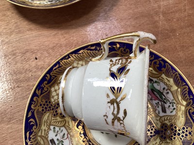 Lot 5105 - 19th century Copeland & Garrett porcelain tea set, comprising 8 saucers, 4 cups and one stand, polychrome painted with flowers and birds on a cobalt blue, pale yellow and gilt ground, some p...