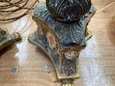 Lot 5107 - Three Italian giltwood and gesso candlesticks, converted to lamps, the central columns supported by shells, on triangular bases with crests, the bases on paw feet, 27.5cm high excluding light fi...