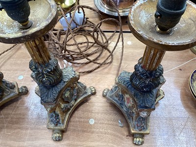 Lot 5107 - Three Italian giltwood and gesso candlesticks, converted to lamps, the central columns supported by shells, on triangular bases with crests, the bases on paw feet, 27.5cm high excluding light fi...