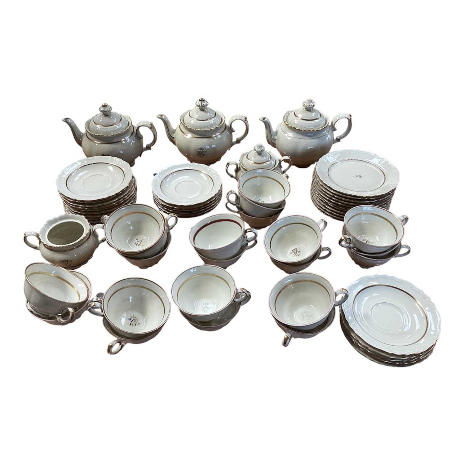 Lot 5112 - Rorstrand Swedish cream and gilt tea set, the rims with raised scroll pattern, comprising three teapots, two sugar bowls and one cover, 11 side plates, 15 saucers, and 21 cups