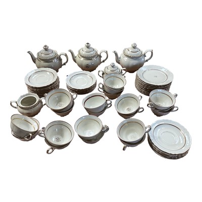 Lot 5147 - Rorstrand Swedish cream and gilt tea set, the rims with raised scroll pattern, comprising three teapots, two sugar bowls and one cover, 11 side plates, 15 saucers, and 21 cups