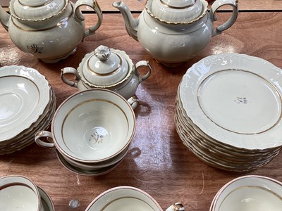 Lot 5112 - Rorstrand Swedish cream and gilt tea set, the rims with raised scroll pattern, comprising three teapots, two sugar bowls and one cover, 11 side plates, 15 saucers, and 21 cups