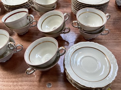 Lot 5112 - Rorstrand Swedish cream and gilt tea set, the rims with raised scroll pattern, comprising three teapots, two sugar bowls and one cover, 11 side plates, 15 saucers, and 21 cups