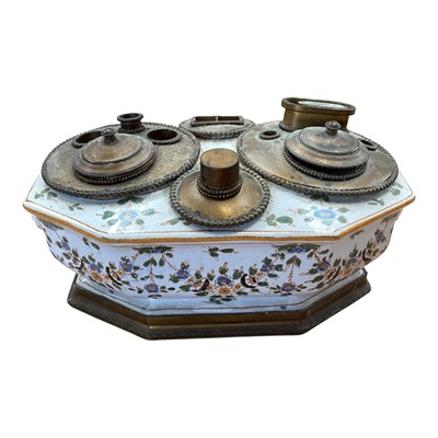 Lot 5108 - 19th century faience inkstand, with lion mask handles, polychrome painted with floral swags, with brass fittings to the top, marked to base, 21cm across