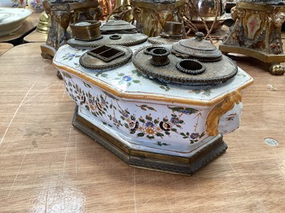 Lot 5108 - 19th century faience inkstand, with lion mask handles, polychrome painted with floral swags, with brass fittings to the top, marked to base, 21cm across