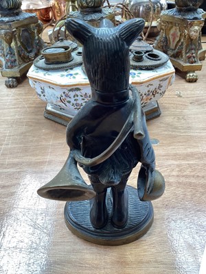 Lot 5114 - Bronze figure of an anthropomorphic boar, modelled with a French horn and a hat, on an oval base, 19cm high