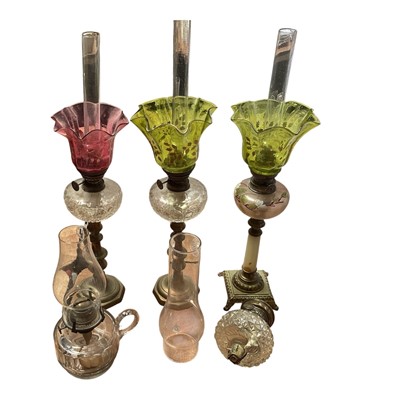 Lot 5119 - Three antique oil lamps with coloured glass shades, two of the burners by Gaudard France, and the other Kosmos, each approx 40cm high excluding chimneys, together with other oil lamp parts