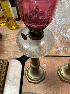 Lot 5119 - Three antique oil lamps with coloured glass shades, two of the burners by Gaudard France, and the other Kosmos, each approx 40cm high excluding chimneys, together with other oil lamp parts