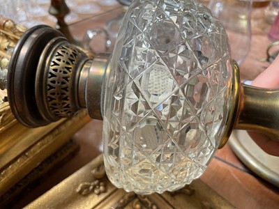 Lot 5119 - Three antique oil lamps with coloured glass shades, two of the burners by Gaudard France, and the other Kosmos, each approx 40cm high excluding chimneys, together with other oil lamp parts