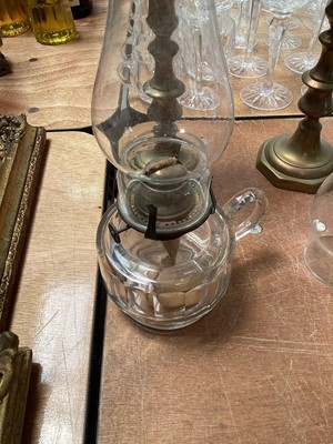 Lot 5119 - Three antique oil lamps with coloured glass shades, two of the burners by Gaudard France, and the other Kosmos, each approx 40cm high excluding chimneys, together with other oil lamp parts