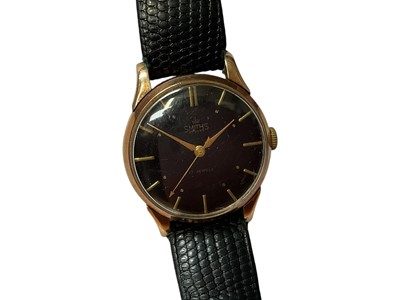 Lot 144 - 1950s Smiths 9ct gold cased wristwatch with circular black dial and baton markers in 9ct gold case (Edinburgh 1955), 32mm diameter, on black leather strap