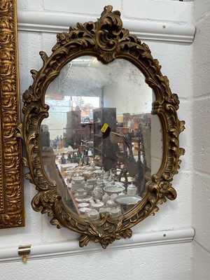 Lot 5176 - Oval gilt gesso wall mirror with scrolling foliage, 64cm x 47cm