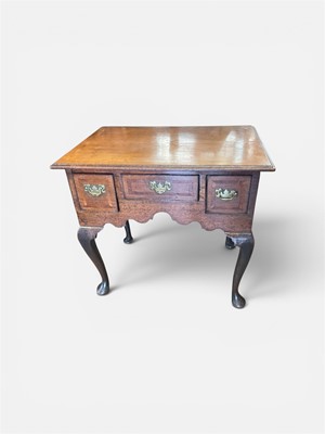 Lot 1512 - A good George III oak lowboy with inlaid star and crossbanded top, three drawers with original brass handles, shaped apron on cabriole legs on pad feet, 76cm wide x 53cm deep x 68cm.