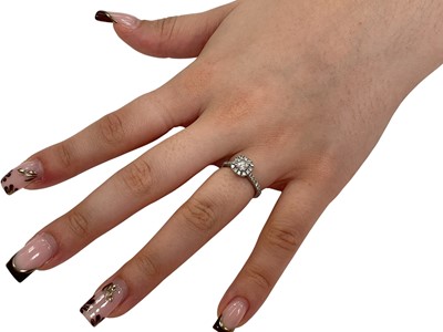 Lot 5 - Lab Grown Diamond Halo cluster ring with a central round brilliant cut Lab Grown diamond weighing 0.52ct, E colour and VVS2 clarity, surrounded by a border of further Lab Grown diamonds with fur...