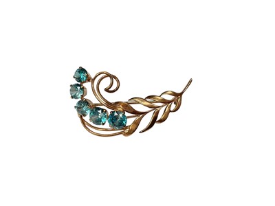 Lot 66 - 9ct gold and blue zircon floral spray brooch