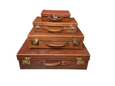 Lot 2584 - Four graduated vintage saddle stitched brown leather suitcases