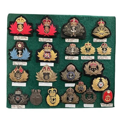 Lot 721 - Collection of twenty one early 20th century and later Royal Navy and other Navy badges to include Imperial German Navy mounted on a baize board, (21).