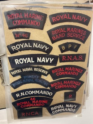 Lot 733 - Collection of mainly Royal Navy cloth badges to include shoulder titles and others, contained within a ring binder album.