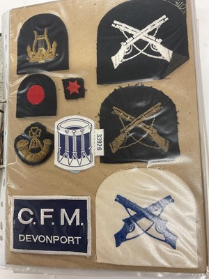 Lot 734 - Collection of mainly Royal Navy cloth badges contained within a ring binder album.