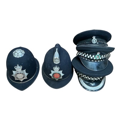 Lot 741 - Elizabeth II Essex Police helmet, Ministry of Defence Police helmet, together with a Royal Parks Police hat and two others, (5).