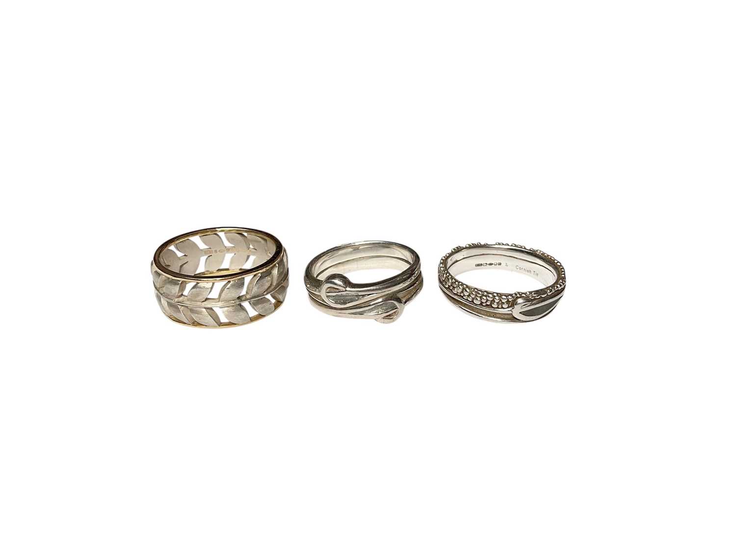 Lot 34 - Contemporary silver and 18ct gold pierced leaf design ring and two other silver rings, all the same maker EJS.